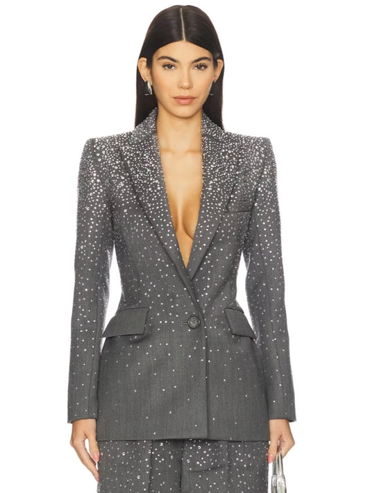 Close-up of the grey crystal-embellished blazer, showing the lapel and front button detail.
