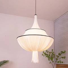 Close-up of a French pendant light, showcasing the delicate texture of the hand-stitched linen shade. B