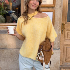 Model wearing yellow cutout one shoulder knit top