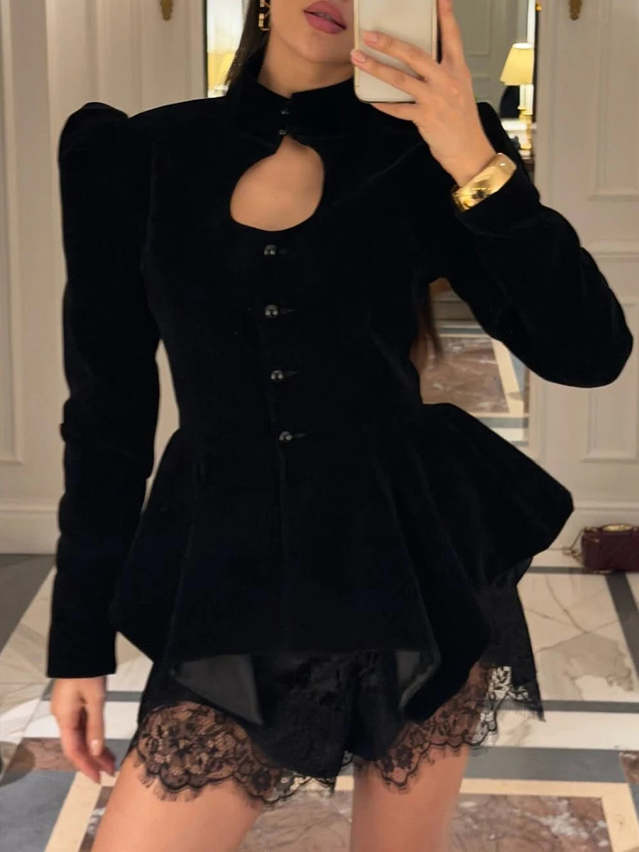 Model wearing a black velvet peplum jacket with a cutout neckline and puffed sleeves.