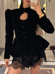 Model wearing a black velvet peplum jacket with a cutout neckline and puffed sleeves.