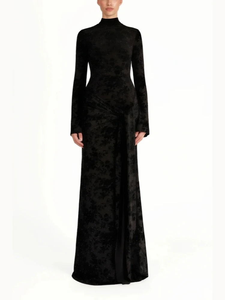 Black evening gown with long sleeves on a white background