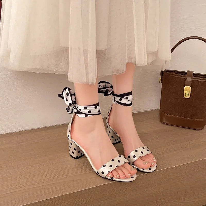 Polka-dot bow heels worn with a white skirt