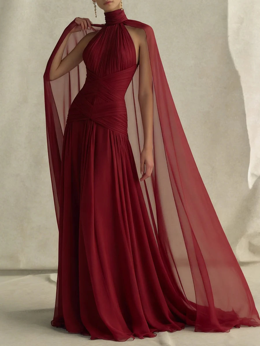 Full length view of a red halter neck cape sleeve maxi dress