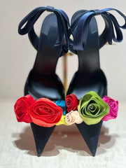 Front view of dark blue stiletto heels adorned with a colorful array of fabric roses.