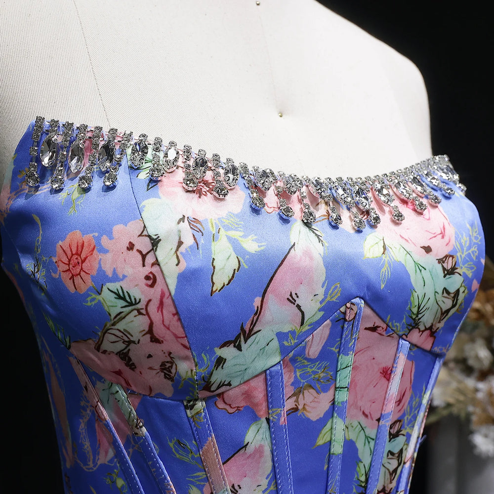 Floral corset with rhinestone details on a mannequin against a dark background