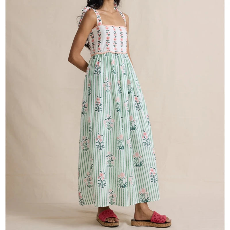 Side view of maxi dress with floral print bodice and green striped skirt