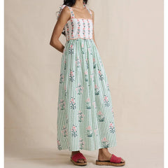 Side view of maxi dress with floral print bodice and green striped skirt