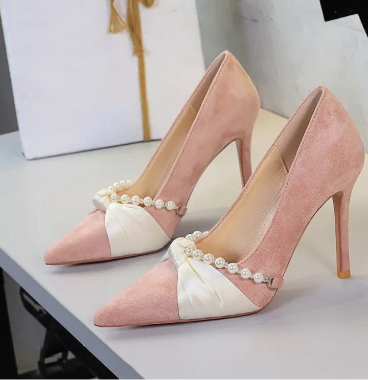 Pink pointed toe pumps with bow and pearl detail