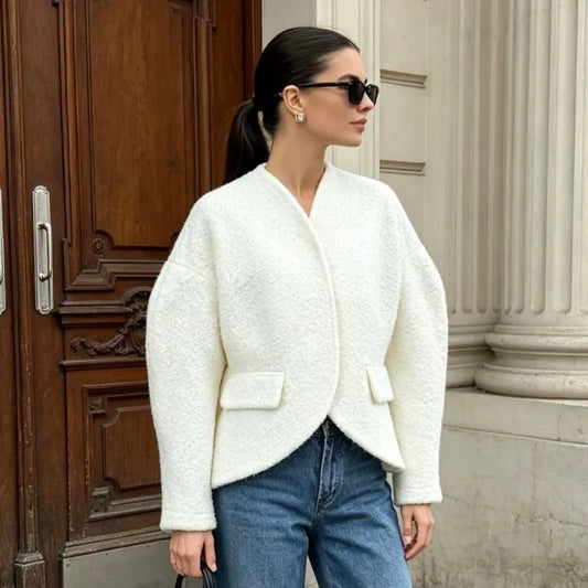 Textured white V-neck cropped blazer with asymmetric hem.