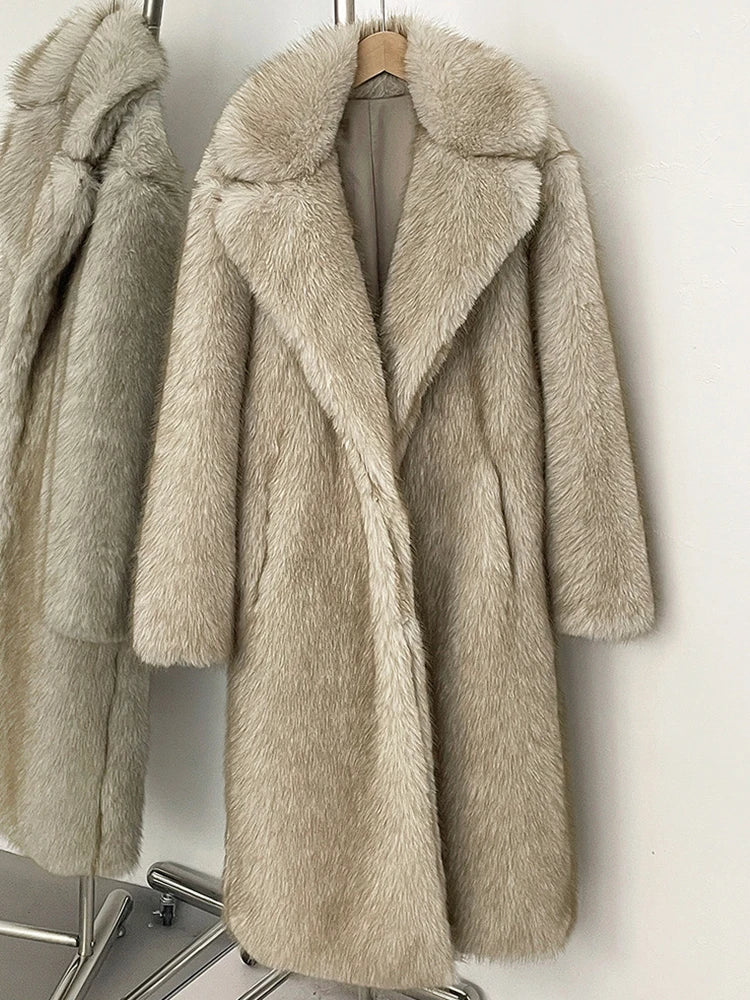 Beige fur coat on a hanger against a white background