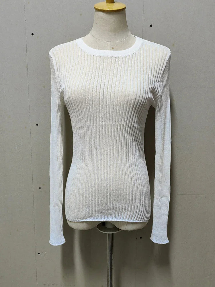 White ribbed long-sleeve top on a mannequin against a gray background