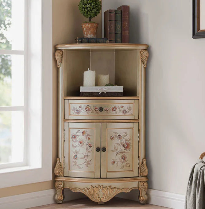Decorative corner cabinet with floral patterns in a room with a window and wall art.
