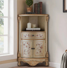 Decorative corner cabinet with floral patterns in a room with a window and wall art.
