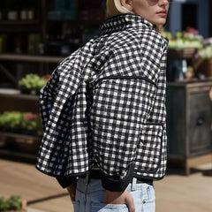A woman wearing a black, white, and gray plaid quilted jacket with a stand neck, showcasing its stylish design  Golden Atelier 3