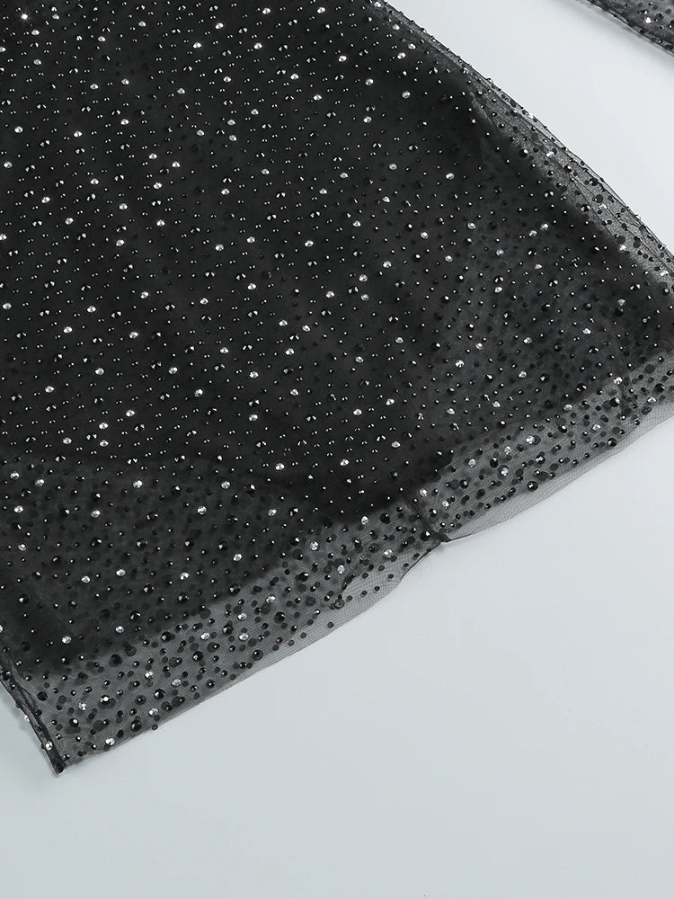 Black fabric with silver sequins on a white background