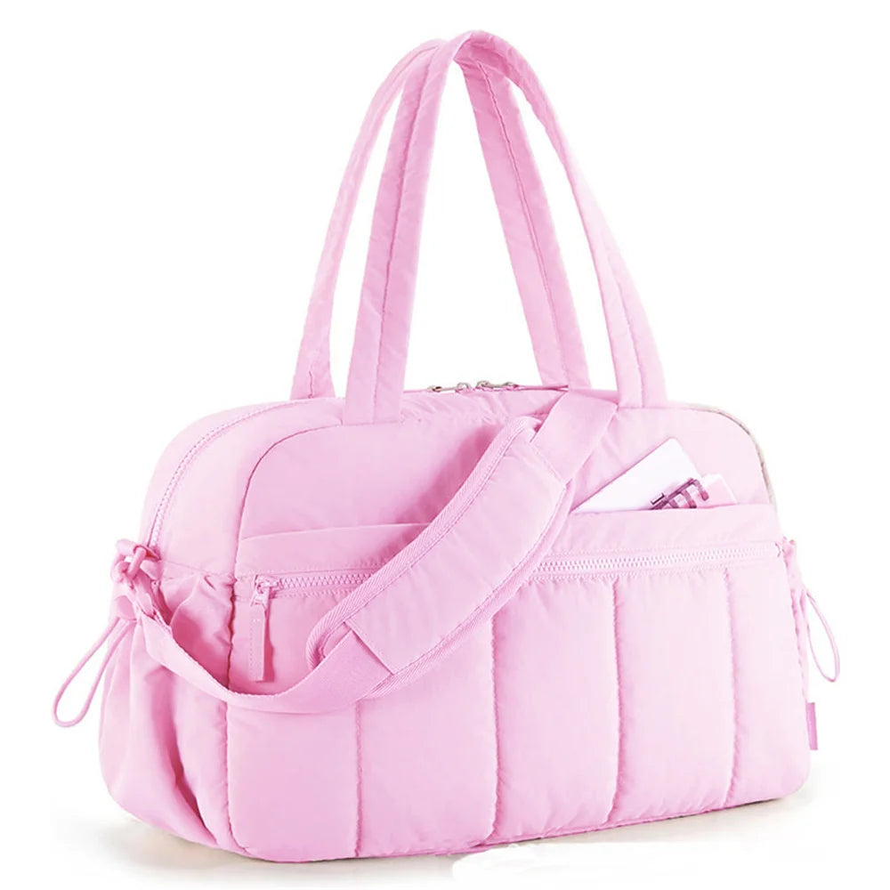 Pink quilted shoulder handbag with strap and sporty style on white background
