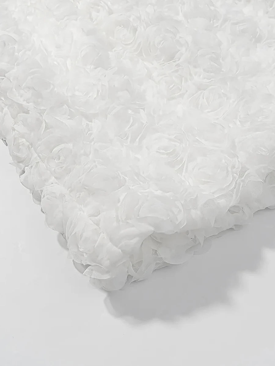 Close-up of a textured white pillow on a light gray background