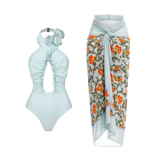 Pale blue floral one-piece swimsuit and matching cover-up skirt.