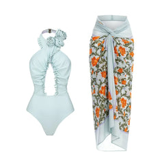 Pale blue floral one-piece swimsuit and matching cover-up skirt.