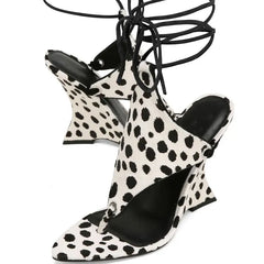 Black and white polka dot high-heeled shoes with pointed toes on a white background