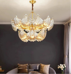 Luxury chandelier hanging in a room with dark walls and a gray sofa.