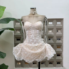 Ivory strapless floral lace mini dress with sequin embellishments.