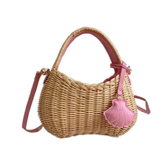 Wicker handbag with pink shell charm on a white background