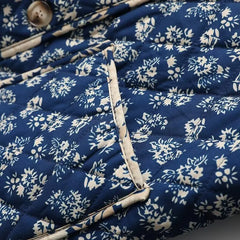 Detail of floral quilted collarless jacket pocket