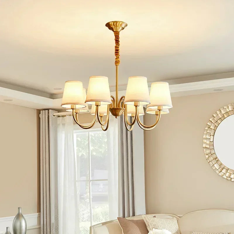 Classic 6-arm cottage chandelier with polished copper, fabric shades, and warm lighting in an elegant living room