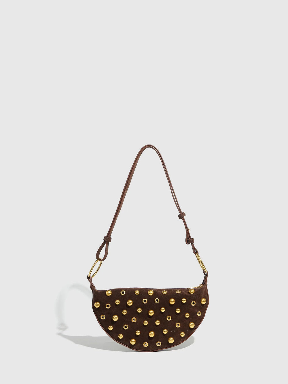 Brown handbag with gold studs on a light gray background