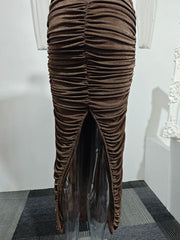 Brown ruched dress on a mannequin against a white wall.