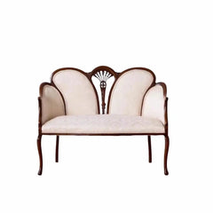 Decorative loveseat with scalloped backrest on a white background