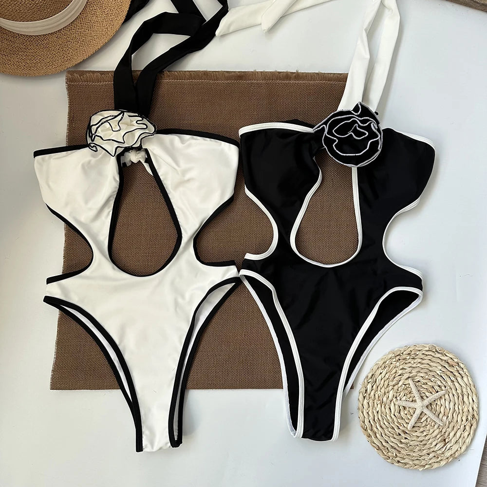 Flat lay of black and white one-piece swimsuits