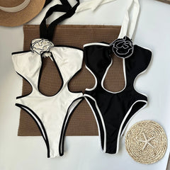 Flat lay of black and white one-piece swimsuits
