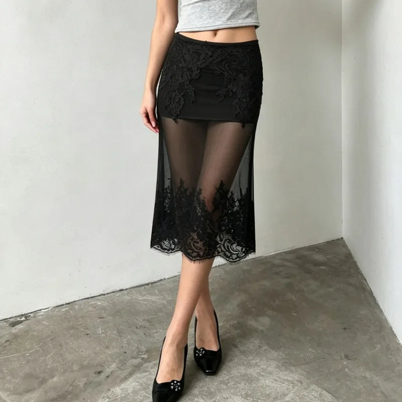 Model posing in a sheer lace midi skirt.
