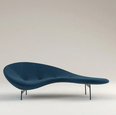 Modern blue sofa with a minimalist design on a light gray background