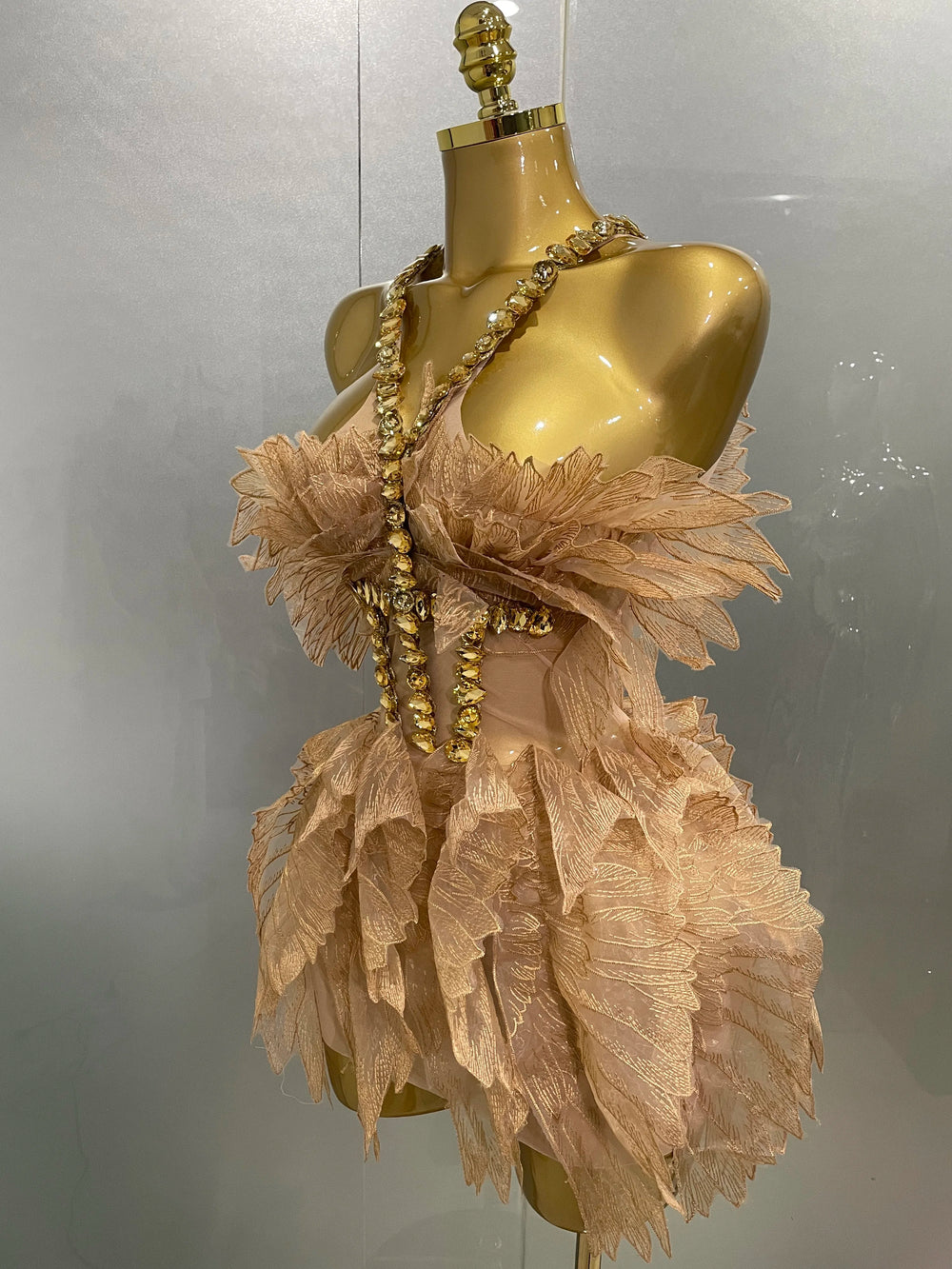 Side view of gold crystal wing mini dress
