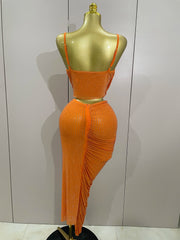 Orange dress on a mannequin against a plain background