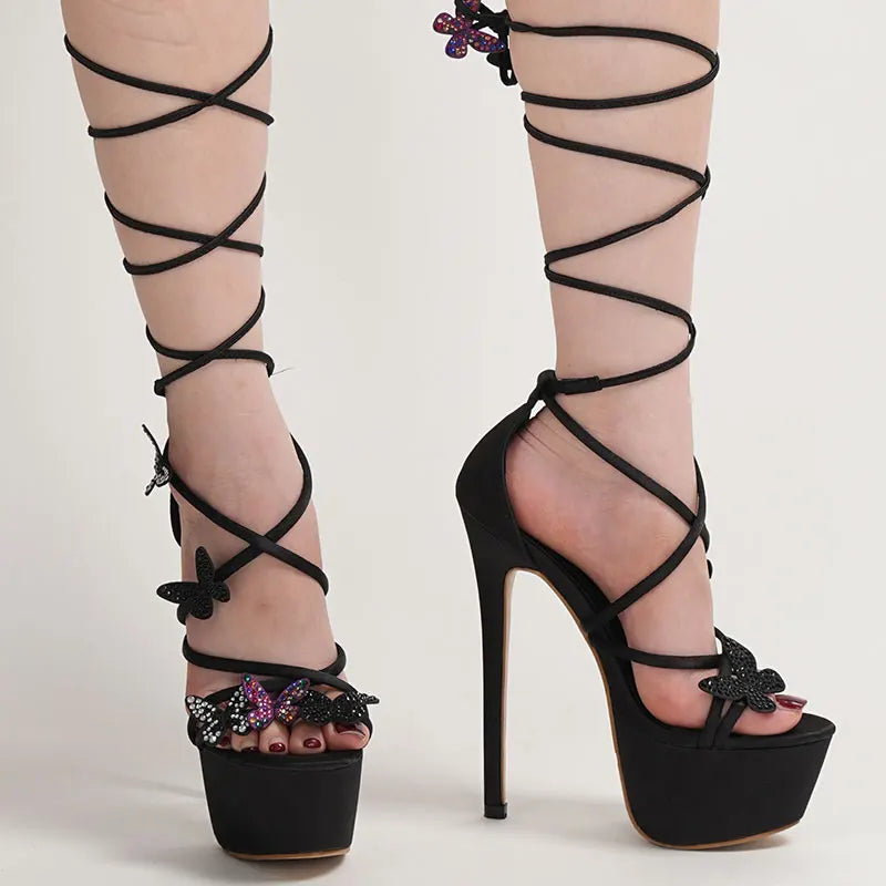 Black strappy high-heeled shoes with decorative bows