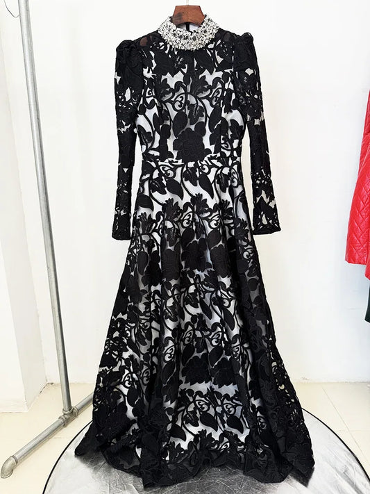 Black embroidered mesh maxi dress with beaded collar on a hanger.