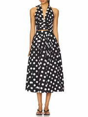 Black and white polka dot halter top and midi skirt set on a white background.