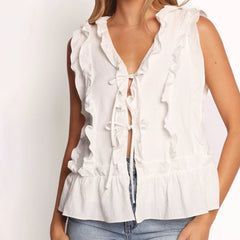 White sleeveless blouse with ruffle details on a plain background