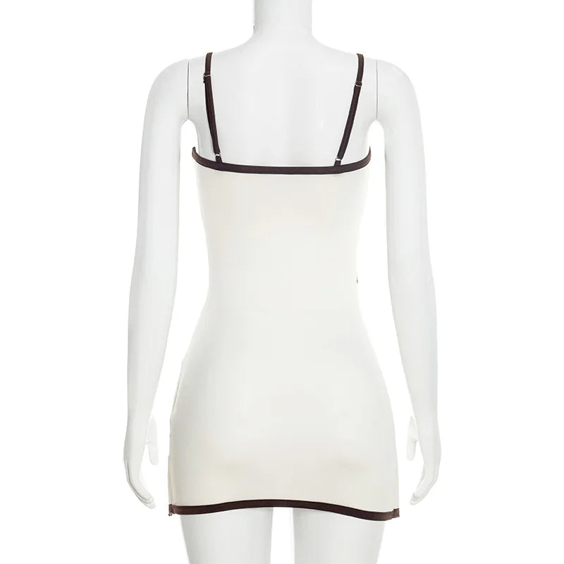 White dress with thin brown straps on a mannequin against a white background