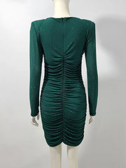 Green dress on a mannequin against a white background