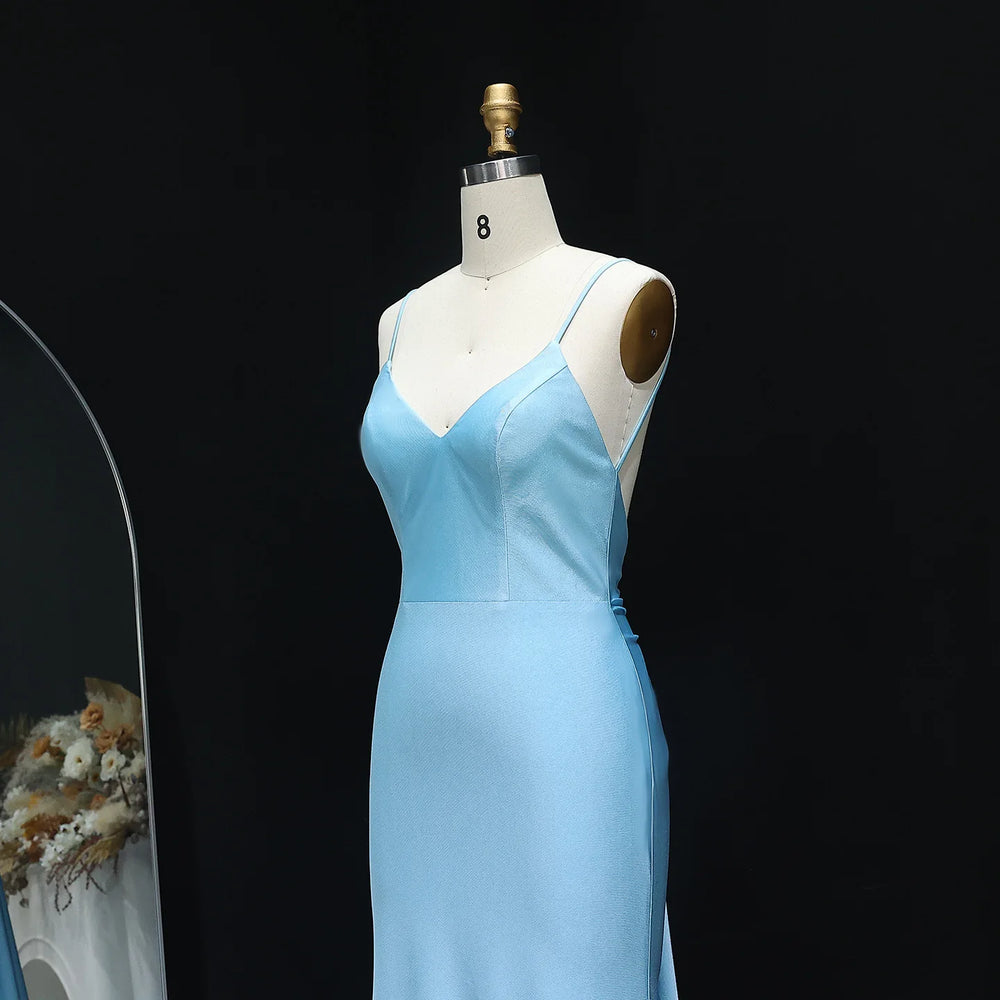 Light blue evening gown on a mannequin against a black background