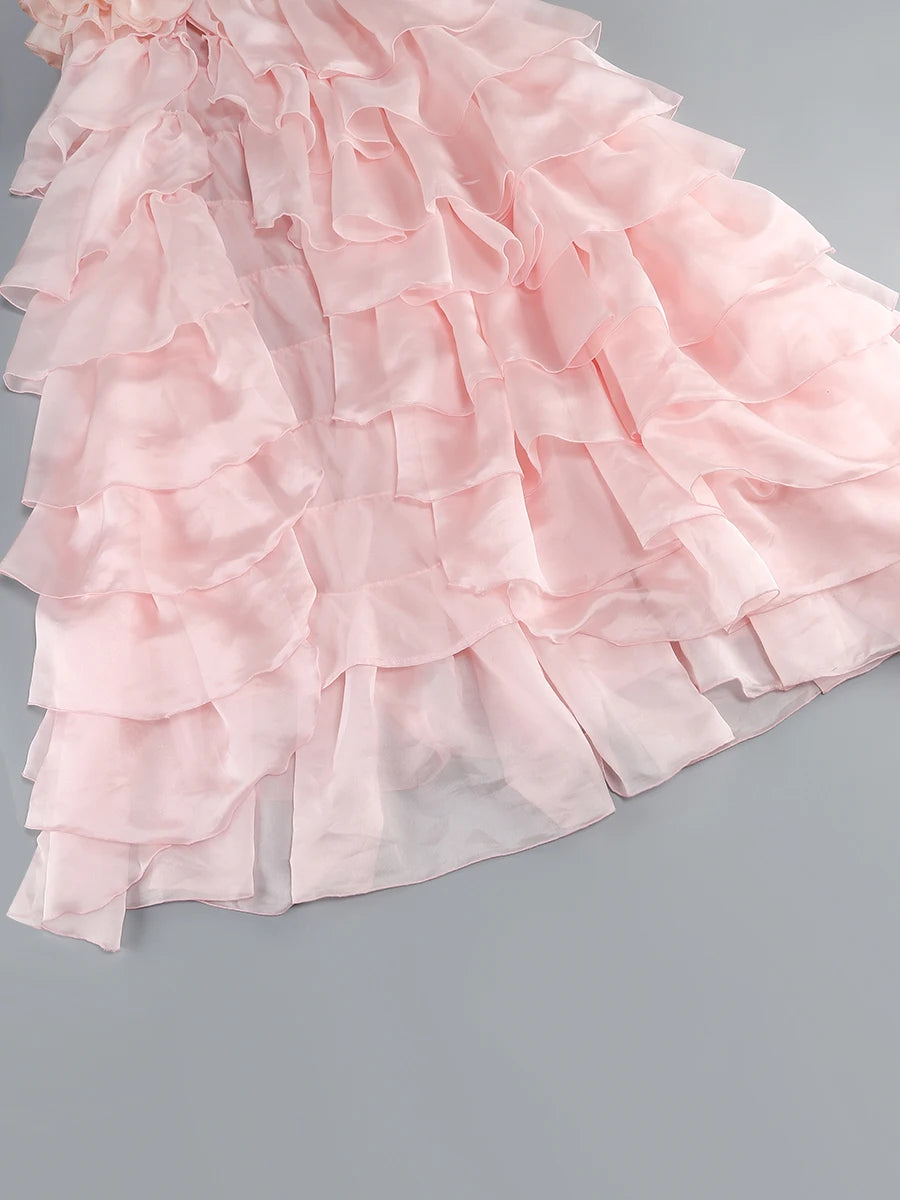 Pink ruffled fabric on a gray background