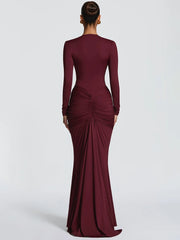 Maroon evening gown with long sleeves on a white background