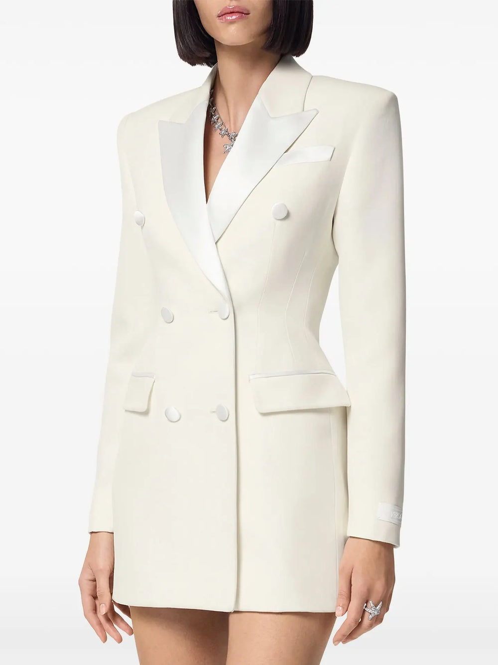 White blazer with black lapels worn by a person 