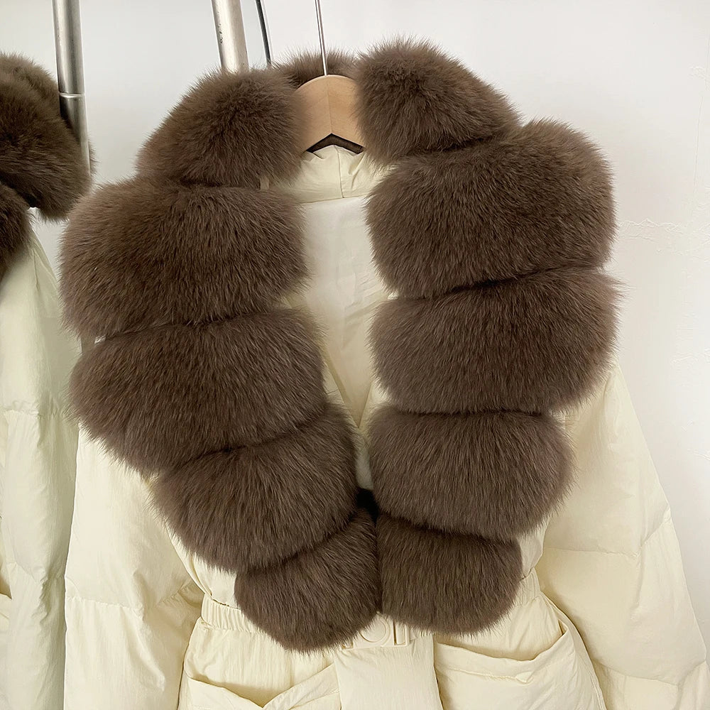 Brown fur scarf draped over a white coat on a hanger